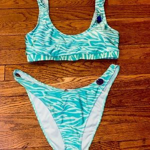 High cut bikini in turquoise zebra print. Bottoms are XL and top is size L.